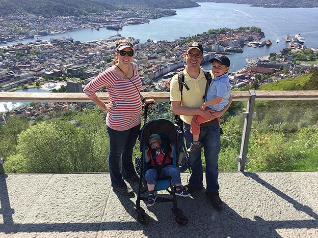 The Newcamp family standing on a hill overlooking the port city of Bergen, Norway
