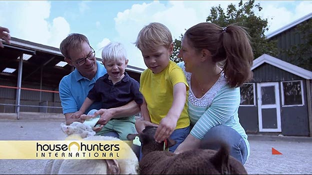 The Newcamp family feeding goats at a petting zoo as seen on House Hunters International