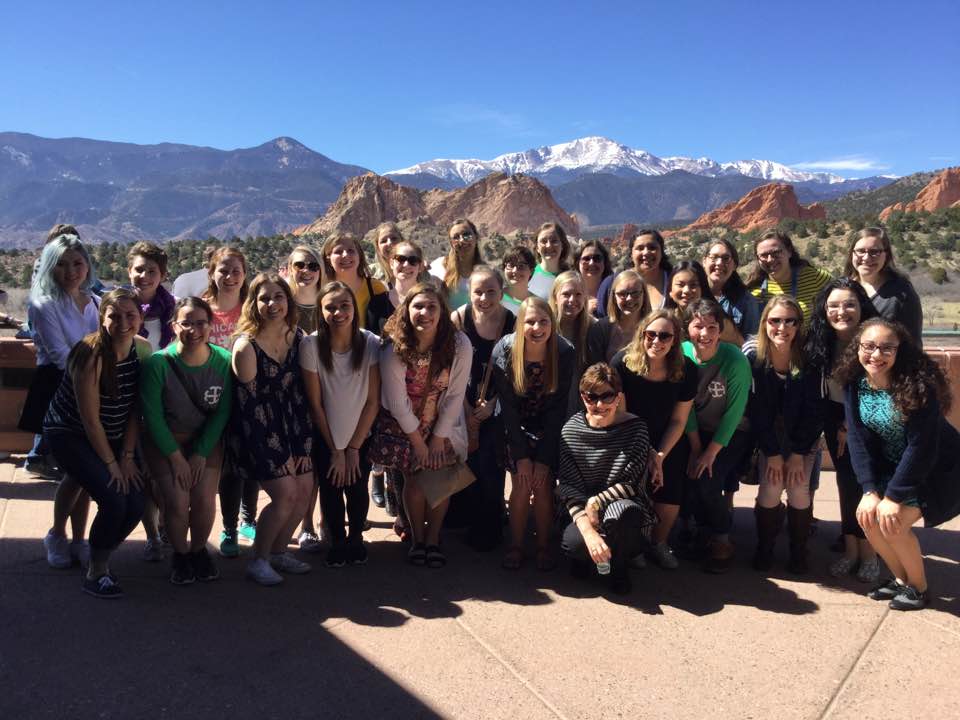 The Saint Mary's Women's Choir posing in front of the mountains of Colorado