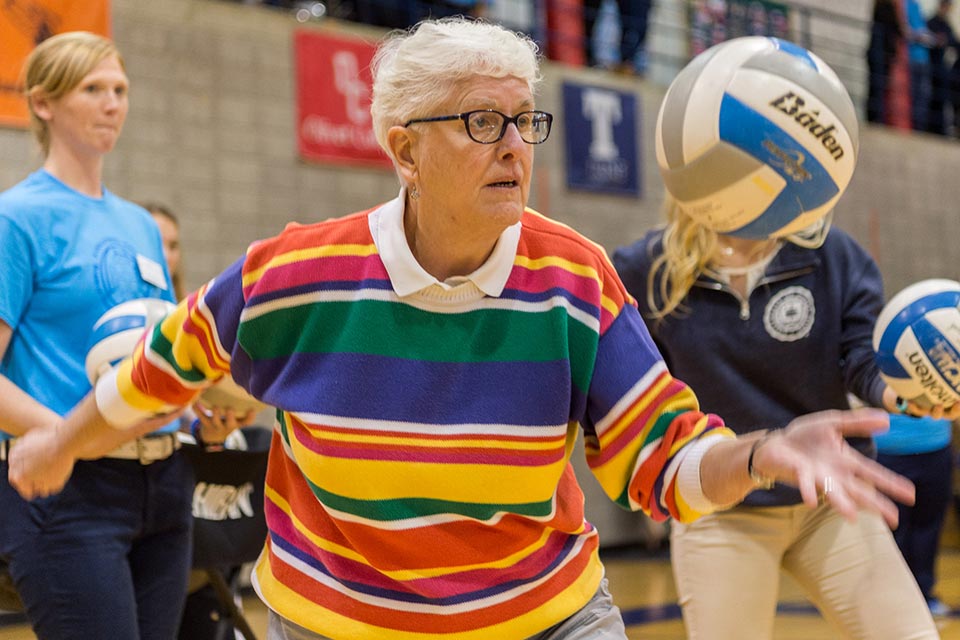 Sister Judith Anne Beattie holds a volleyball as she prepares to serve