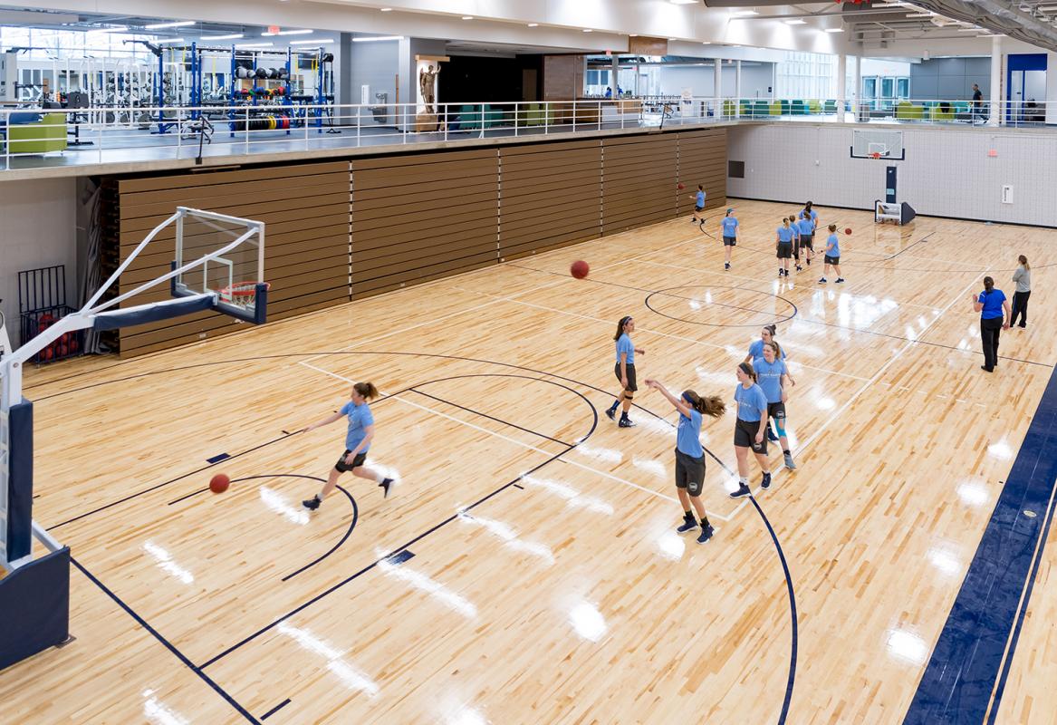 Basketball team practicing on the lower level performance court.