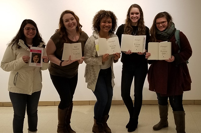 Students posed with signed Roxane Gay photos