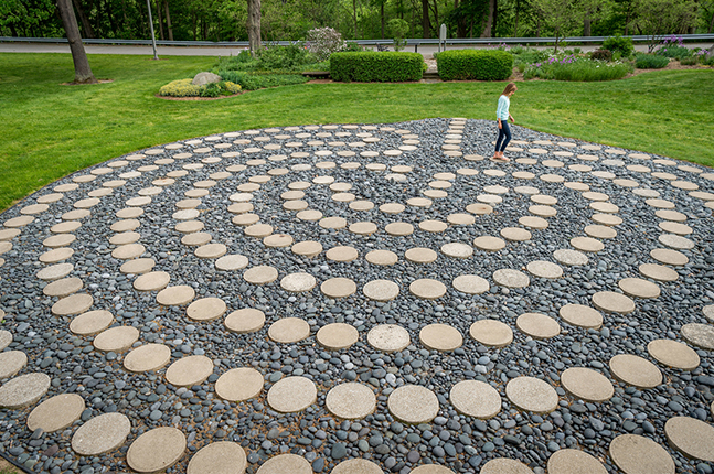 A student walks the campus labyrinth