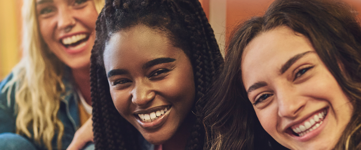 Three smiling young women