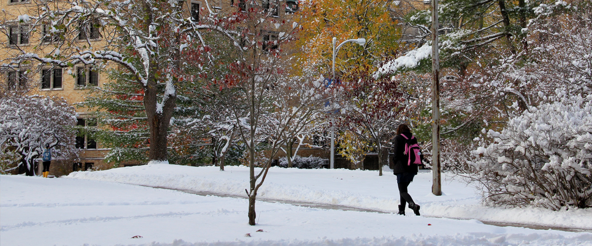 Winter scene with student walking towards Le Mans Hall