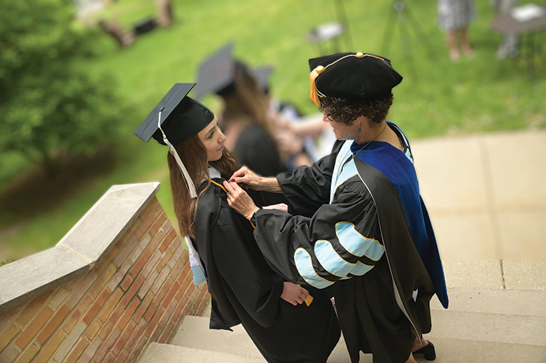 President Conboy assisting a graduate