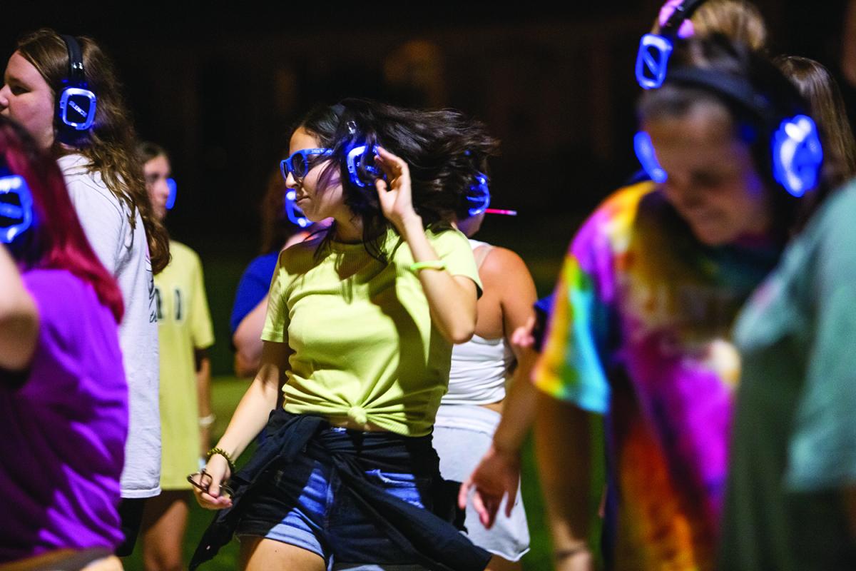 Students donned headphones during the Rave Around the World Silent Disco (right)