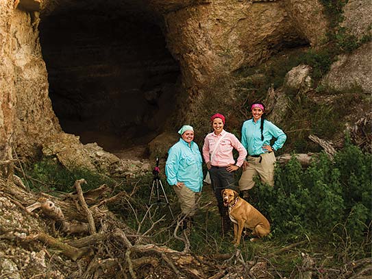 Cassi Mardis '17, Professor of biology Laura Kloepper, and Stephanie Dreessen '17 outside a bat cave in Aetna, Kansas