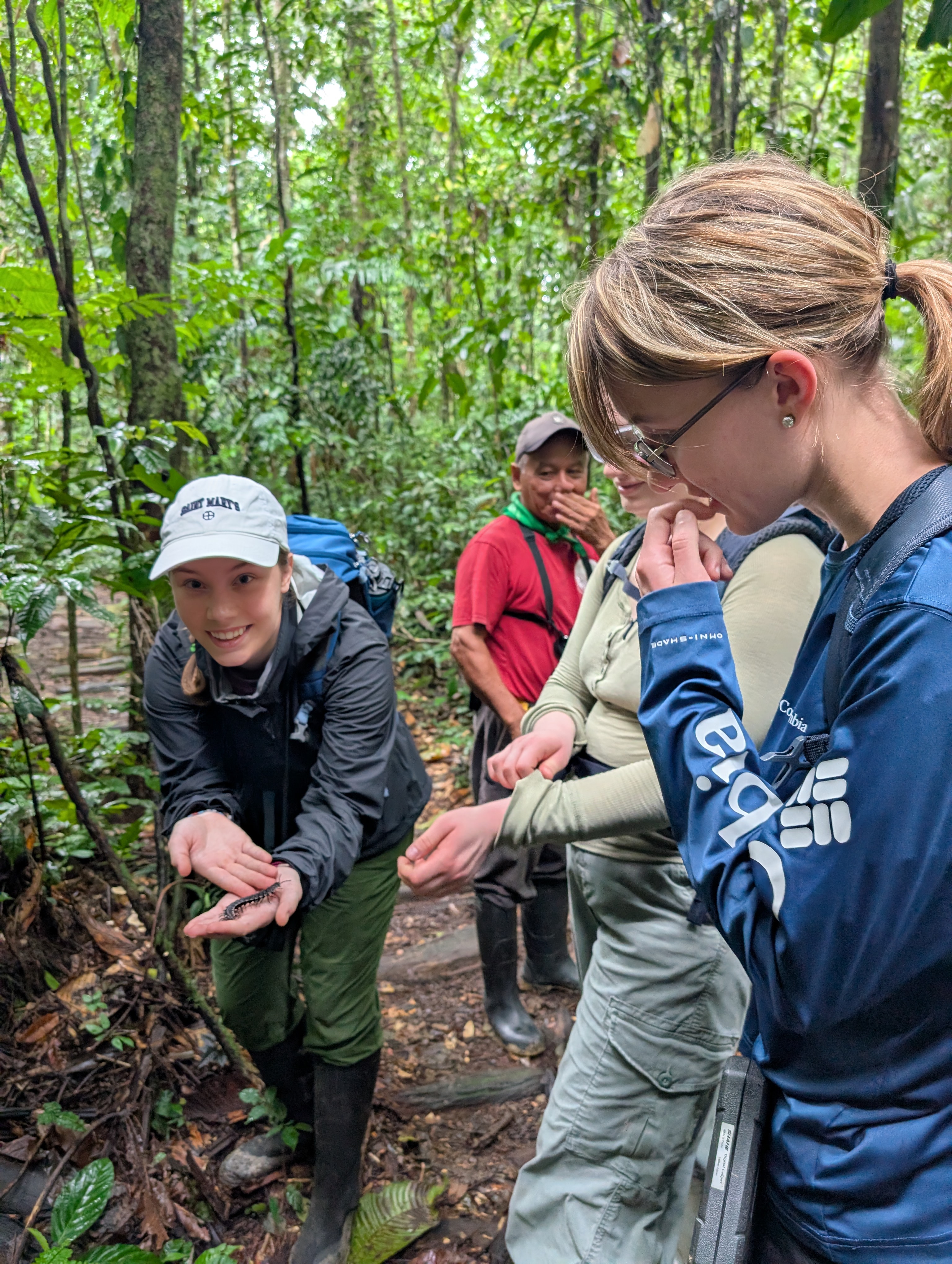Grace Katsekes '26, left, gets up close with one of the myriad species of insects in the Ecuadorian Amazon.