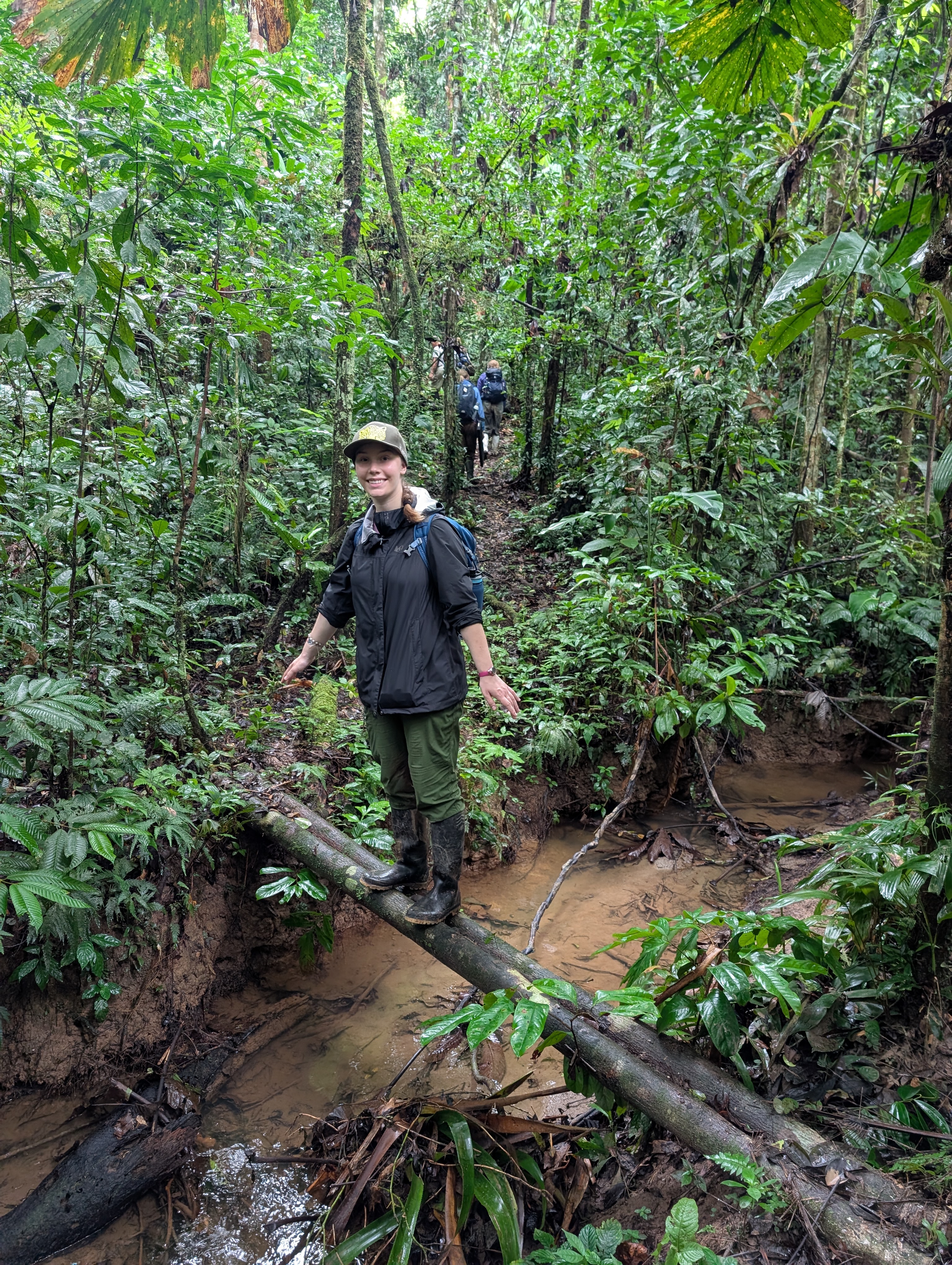 Grace Katsekes '26 crosses a stream on a hike in Ecuador.