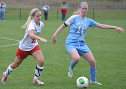 Mary Kate Hussey plays the ball away from Olivet's Lauren Vanderhoff. (photo credit: Rebeka Wiersma)