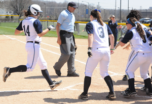Angela Dainelli comes in to touch home after hitting a solo home run.