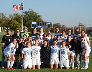 The Belles soccer team huddle up after their season-ending win against Hope.