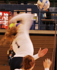 Melanie Kuczek (1) goes up for a ball.