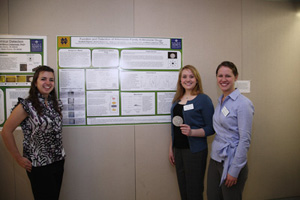 Meghann Mouratides '12, Amelia McGannon '11, and Liz Bajema '11 in front of their poster.
