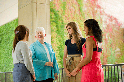 President Mooney visits with Saint Mary's students.