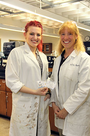 Chemistry professor Toni Barstis, right, and Mary Bevilacqua '12 enhanced the PAD (pictured) to include what Bevilacqua calls the “capillary method.” The fabrication enables safe handling of harsher chemicals needed to screen certain pharmaceuticals.