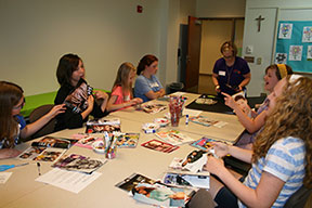 Girls at the 2014 "Bloom for Girls" seminar participate in a "What is Beauty?" workshop. The girls used fashion magazines to create collages to show inner verses outer beauty with the knowledge they gained that day.