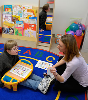 A Saint Mary's College communicative disorders student works with a child in a lab.