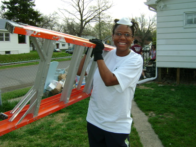 Volunteer carrying ladder