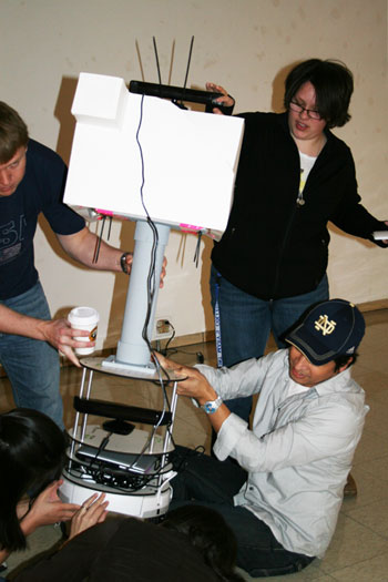 Saint Mary's art student Megan Archer '13 works with Notre Dame students on a robotic prototype last fall in a pilot program for the class.