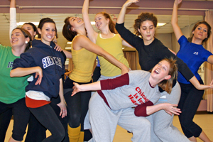 group of students with arms up