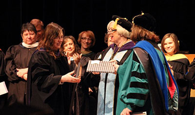 Julie Storme, professor of modern languages and interim associate dean of faculty, is honored with the Spes Unica Award at Honors Convocation.