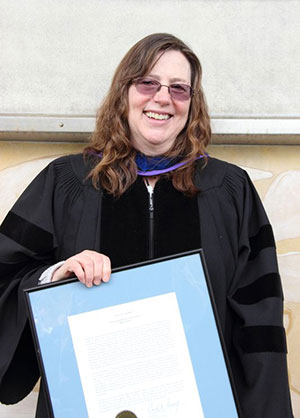 Professor Julie Storme poses with the Spes Unica Award, which she received at Honors Convocation.