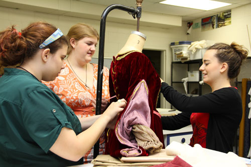 Students work on details of a Madrigal Dinners costume.