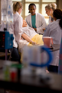 nursing students working with simulated patient