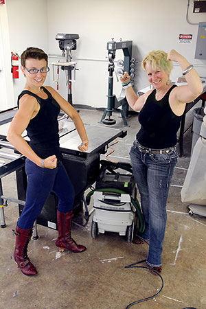 Professors Marne Austin, left, and Terri L. Russ playfully show off their female power while talking about the research projects they’re doing concerning area women and girls. Both teach communication studies and gender and women’s studies.