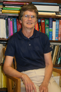 mary porter in front of a bookshelf