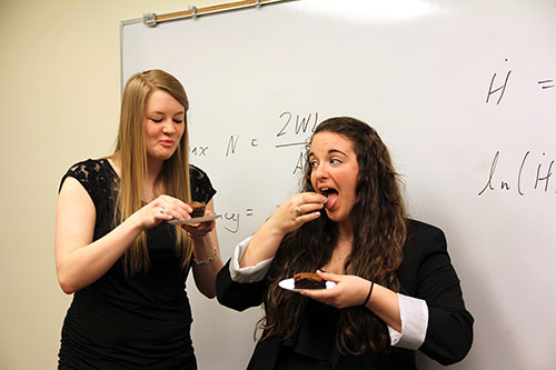 Olivia McIntee '13, left, and Samantha Brown '13, enjoy a brownie and a laugh. Their math problem was to figure out the ideal shape of a brownie pan so the edges aren't burnt. Their answer: a hexagonal pan!