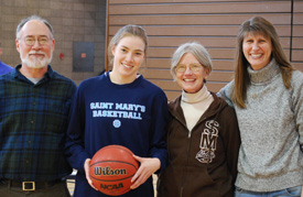 Patsy Mahoney was given the game ball with which she scored her 1,000th point before the start of the Belles' win.