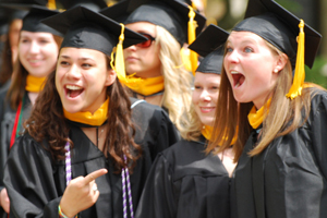 Lumen Christi award recipient Patty Duffy (left) points to classmates