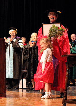 Mia Kaminski soaks up the applause after presenting a bouquet of roses to her great-aunt, professor of religious studies Phyllis Kaminski. The professor is this year's recipient of the Maria Pieta Award.