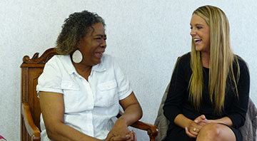 South Bend resident Sheila Muhammad, left, and Morgan Carroll ’15 share a laugh. The two became good friends through a six-month service project during which Carroll recorded and transcribed Muhammad’s story about living with AIDs for her family.
