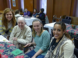 Saint Mary’s College students and Sister Jane Frances Reus, CSC, are all smiles as they celebrate the completion of an oral history class project that evolved into eye-opening experiences of faith-sharing and friendship for both students and Sisters of th