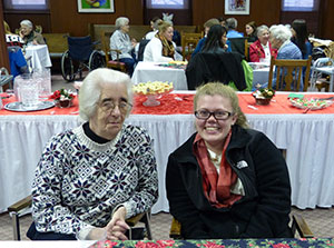 Saint Mary’s College student Jackie Rooney '17, right, and Sister Susan Kintzele, CSC, enjoy refreshments and each other’s company during a reception celebrating the completion of the oral history class project.