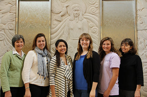 Some of the organizers of the Voices of Young Catholic Women project pose in front of the Our Lady of Wisdom water well at Saint Mary's College. Judy Fean, director of Campus Ministry, is far left, and Elizabeth Groppe, director of the Center for Spiritua