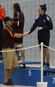 Audrey Dalrymple is congratulated on her fifth place finish in the 200 IM. (Photo courtesy Jeff Febus, Calvin College)