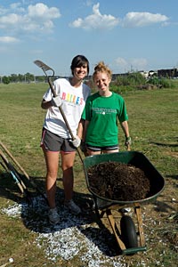 Student Body President Nicole Gans '12, left, and Vice President Jackie Zupancic '12 did community service with the Unity Gardens in South Bend this summer during the kickoff retreat for the Student Government Association.