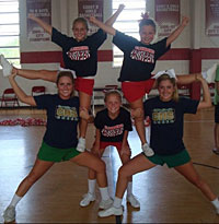 Katie, bottom left, and her sister, Sarah, bottom right, help younger students with cheerleading.