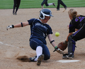 Kristen Nelson slides in ahead of the throw and scores a run in game two at Albion.