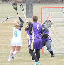 Hanna Makowski (left) crosses over before scoring against Defiance on Thursday.