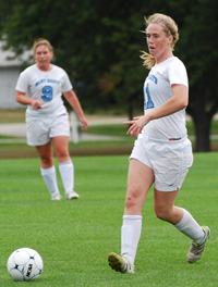 Mary Kate Hussey clears the ball against Alma on Thursday as Anna Stollhans looks on.