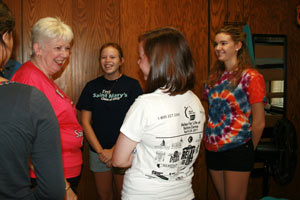 Saint Mary's College President Carol Ann Mooney '72 chats with Mary Nagle '15, foreground, in McCandless Hall on Thursday. Looking on are Nicole Brown '15, in blue shirt, and Alex Lazarian '15, right.