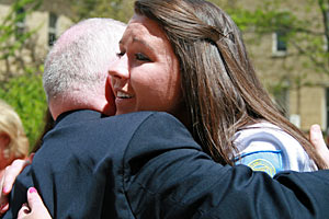 Nursing student Elizabeth Kelly hugs her best friend's father after the Nurses Pinning Ceremony.
