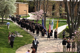 A procession of honors graduates and faculty heads to O'Laughlin Auditorium for Honors Convocation.