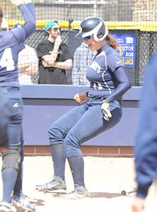 Jillian Busfield comes in to score on her school record-setting 23rd career home run.
